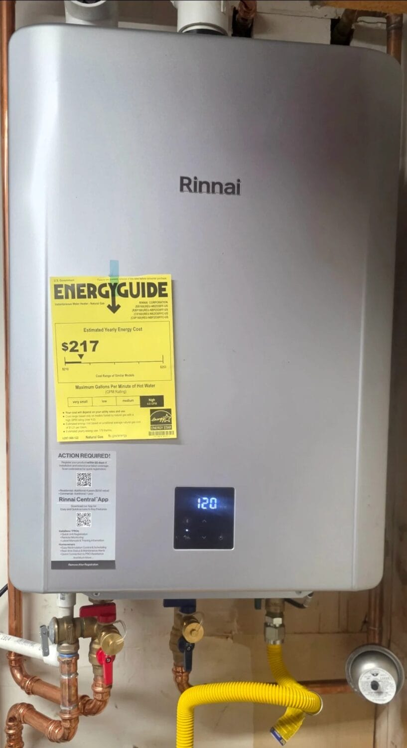 A Rinnai tankless water heater, professionally installed with expert tankless water heater installation, features an EnergyGuide label showing an estimated yearly energy cost of $217. Mounted on a wall with visible pipes and a digital display reading 120, this setup demonstrates both efficiency and modern convenience.
